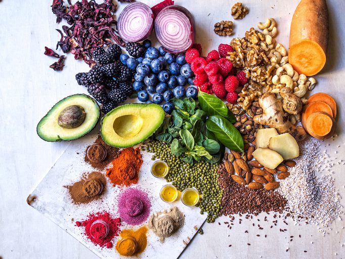 Anti-inflammatory vegetables, fruits, legumes, nuts and spices relieving health problems - vegetables, fruits, legumes, nuts and spices for health benefits on wooden table - healthy eating, superfood, copy space